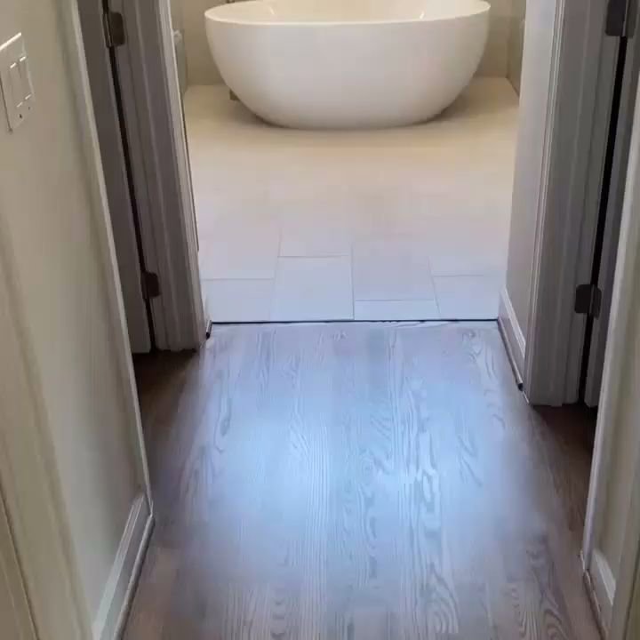 Dark wood flooring installed in a hallway by Santizo Flooring & Painting in Raleigh, NC.