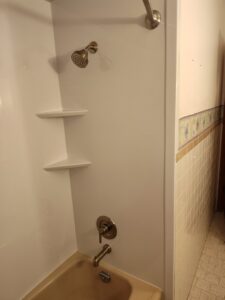 A dated bathroom featuring an old tub and shower combination, typical of projects handled by Bath Planet of STL & More in Saint Charles, MO.