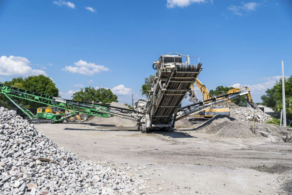 Large debris crushing and screening equipment processing materials at Global Recycling of Tampa Bay in Tampa, FL.