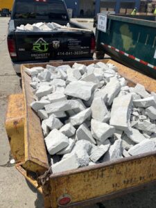 A trailer filled with broken concrete debris, ready for removal by RT Property Services in Allendale, MI