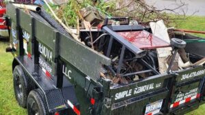 A junk removal trailer filled with debris and branches by Simple Removal LLC in Follansbee, WV.
