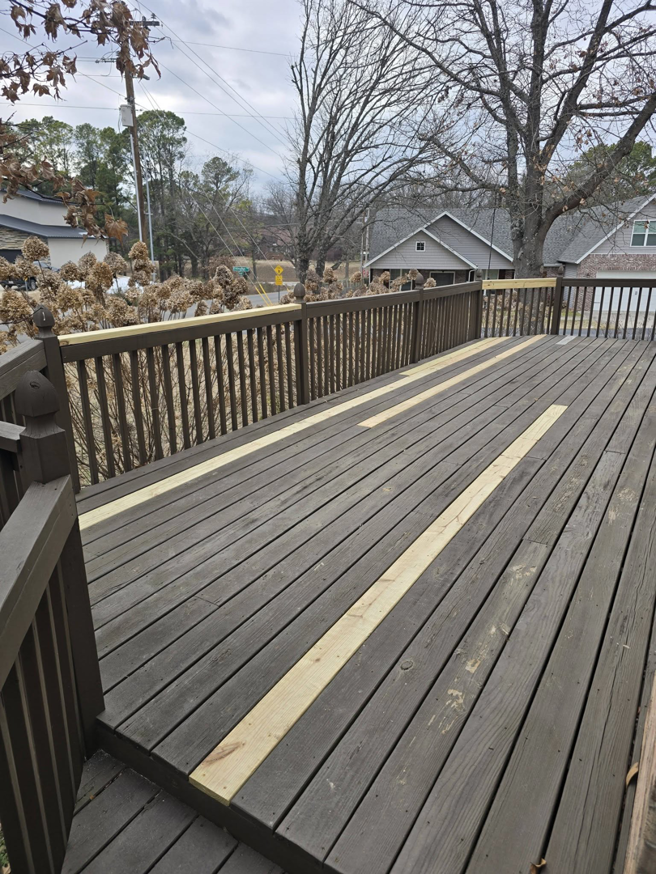 A wooden deck with new boards installed, showing deck repair work by Creekside Handyman NWA in Centerton, AR.
