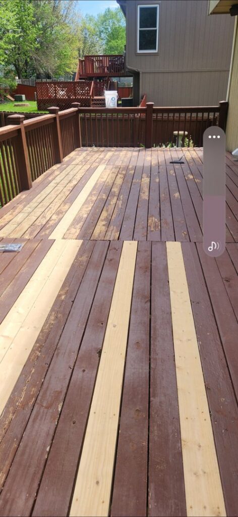 Outdoor deck with new wood planks replacing old ones, showing deck repair in progress by Go Joe Handyman in Overland Park, KS.