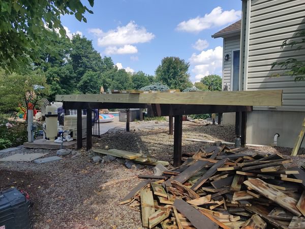 Deck building project in progress, showing the wooden frame and construction debris by NS Construction in Imperial, CA.