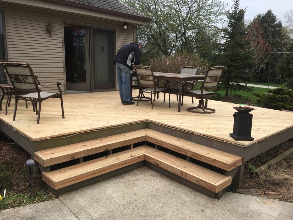 A handyman from Top Notch Contracting working on a new wooden deck in Racine, WI.