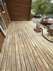 A wooden deck being cleaned and prepared for treatment by ThoroughFair Renovations in Lawrence, KS.