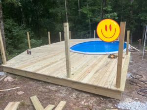 Deck construction in progress around an above-ground pool by S & H Painting and Drywall LLC in Montgomery, AL.