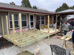 A new wooden deck under construction, showing framing and tools, by B&B Handyman Solutions in Omaha, NE.