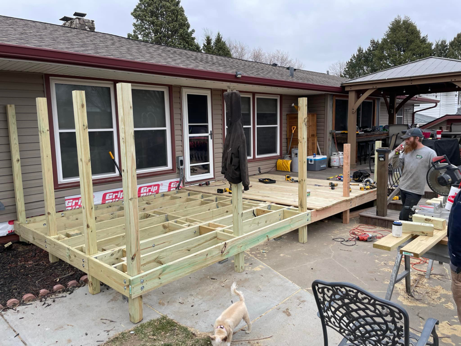 A new wooden deck under construction, showing framing and tools, by B&B Handyman Solutions in Omaha, NE.