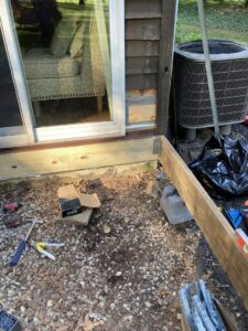 Deck construction in progress, showing wooden framing and tools on the ground by DCM Multi Service llc in Harrisburg, PA.