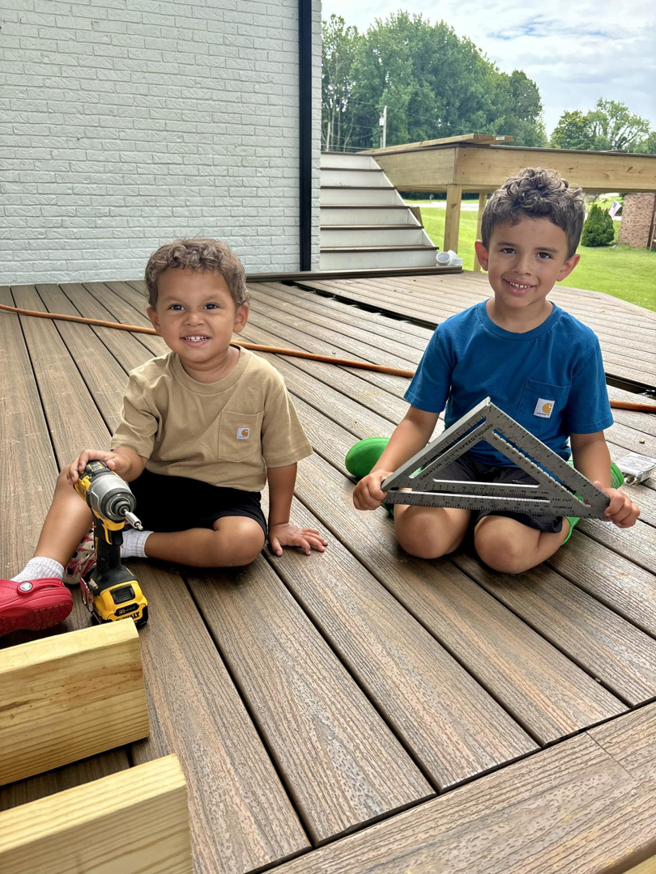 Children with construction tools on a deck under construction, representing a project by DELM Construction & Remodeling LLC in Evansville, IN.