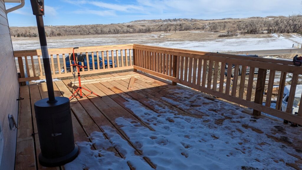 A wooden deck under construction, showing progress on a project by Devil Dog Services LLC in Billings, MT.