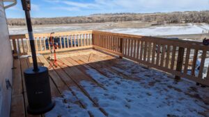 A wooden deck under construction, showing progress on a project by Devil Dog Services LLC in Billings, MT.