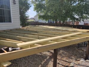 Wooden deck frame under construction, showcasing the progress of a new deck build by NS Construction in Imperial, CA.