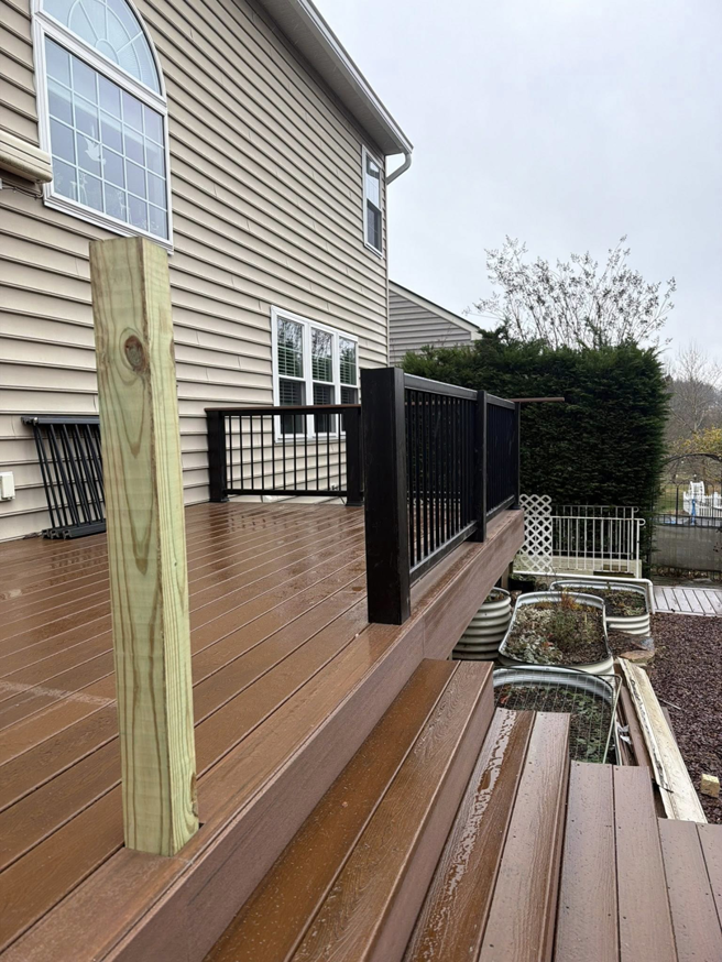 A view of deck construction with new railings and a wooden post by Harris Home Creations in Philadelphia, PA.
