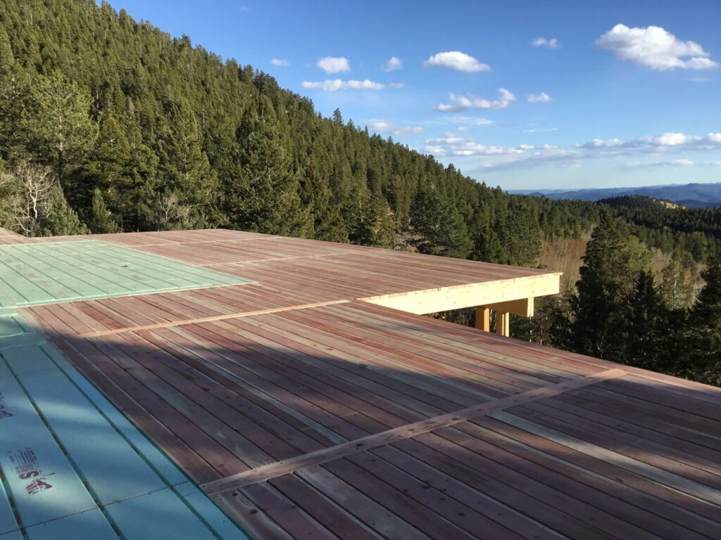A deck construction project in progress with a scenic mountain view, handled by Lnk Deck & Remodels, LLC in Aurora, CO.