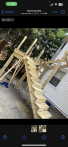 A new wooden deck and stairs under construction next to a house by SGT. Handyman services RI in Downtown Pawtucket, RI