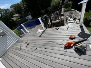 Deck construction in progress with tools on the newly laid composite decking, by Sini's Handyman Services in Falmouth, ME.