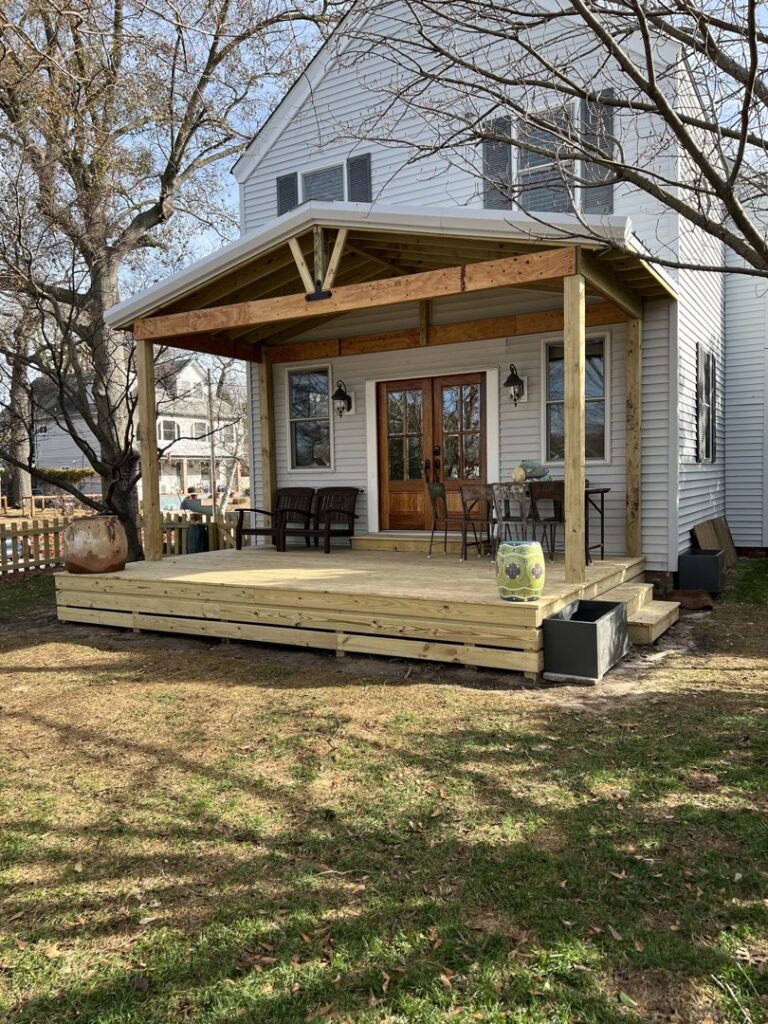 Workers constructing a new composite deck, showcasing a handyman job in progress by Dutch Deck and Fence in Norfolk, VA.