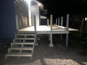 Deck construction in progress at night by TD Estimating Group LLC in Springfield, MA, showing the framework and stairs.