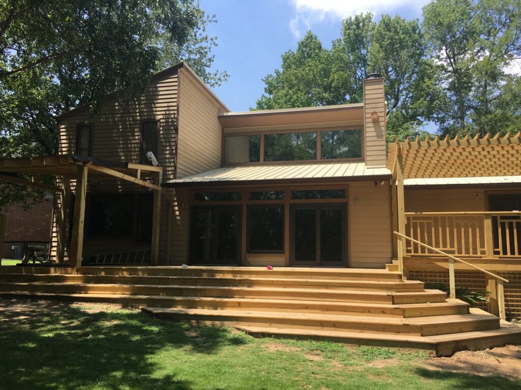 A large wooden deck and pergola under construction or repair, showcasing handyman services by Augusta Sun & UV Control in Augusta, GA.