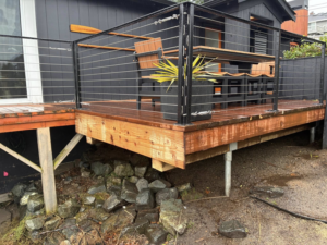 Deck construction with new support structure by Precision Coatings LLC Siding and Painting Specialist in Tacoma, WA.