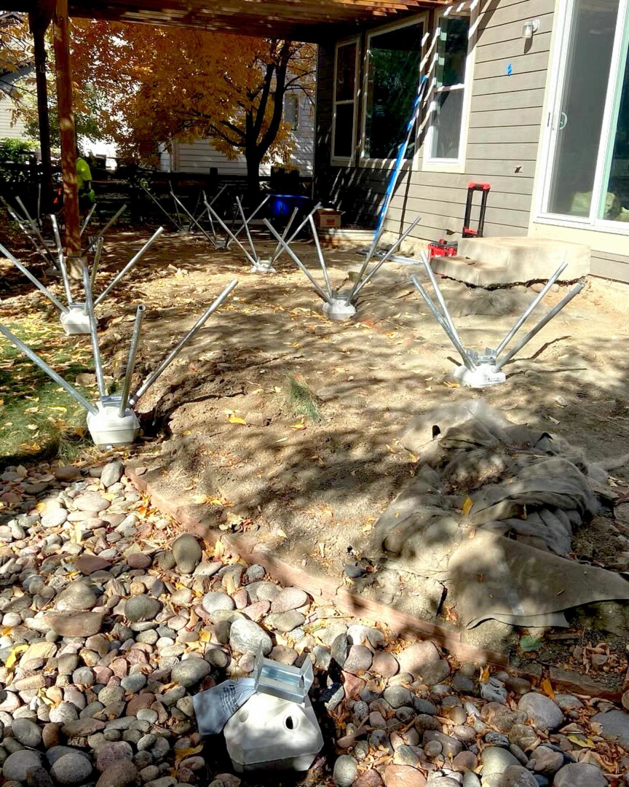 Deck foundation piers installed on the ground, ready for construction by TNC Builders, LLC in Aurora, CO