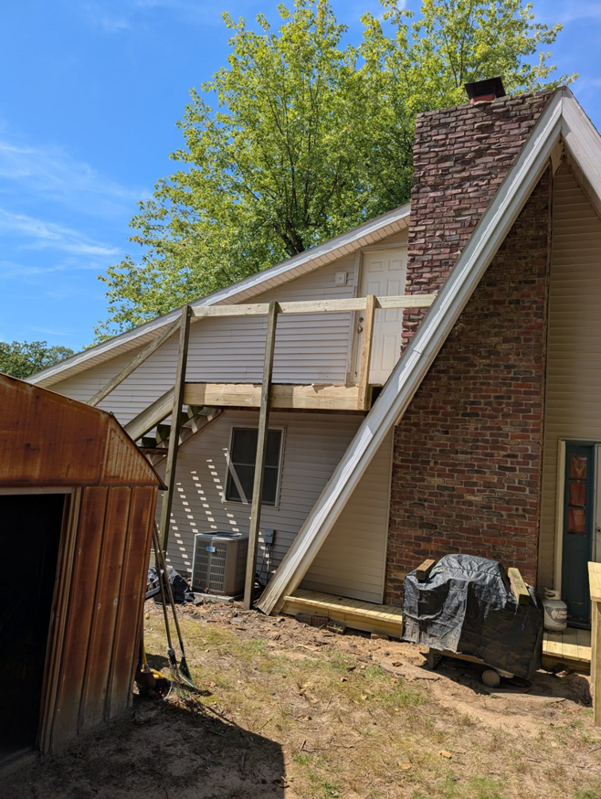 Exterior view of a house with new deck framing under construction by Handyman Service in Lafayette, IN.