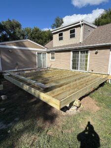 The sturdy wooden framing and joists of a new deck under construction by Midwest Home Remodeling & Design LLC in Chicago, IL.