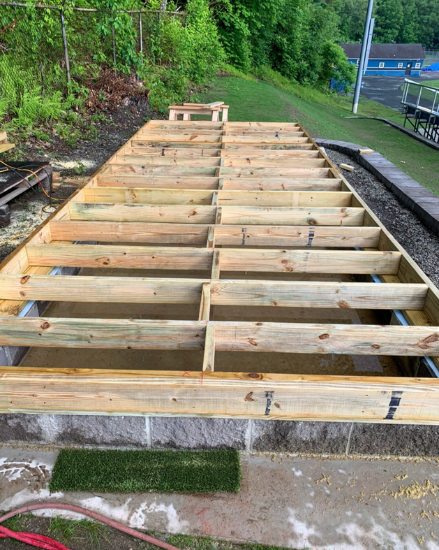 Wooden deck framing under construction, showing new lumber joists, by Yellow Ladder Contracting in Mount Pleasant, SC