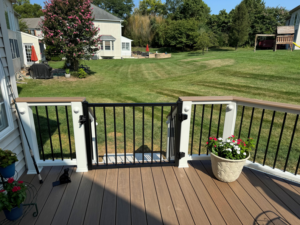 A newly installed black metal gate on a composite deck railing by Sundecks, Inc. in Manassas, VA.