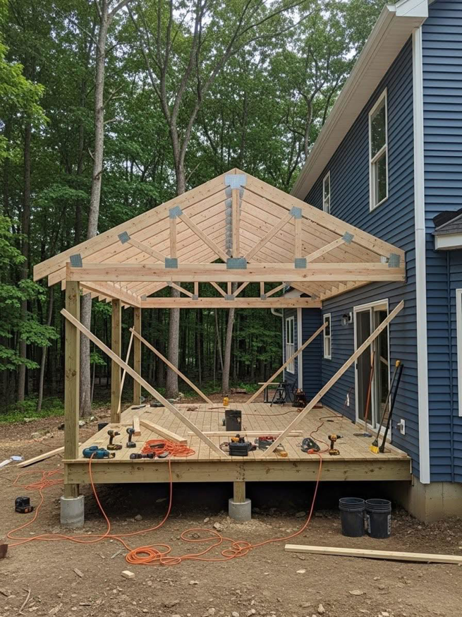 A large wooden deck and patio roof under construction by Forward Construction for a home in Florence, KY.