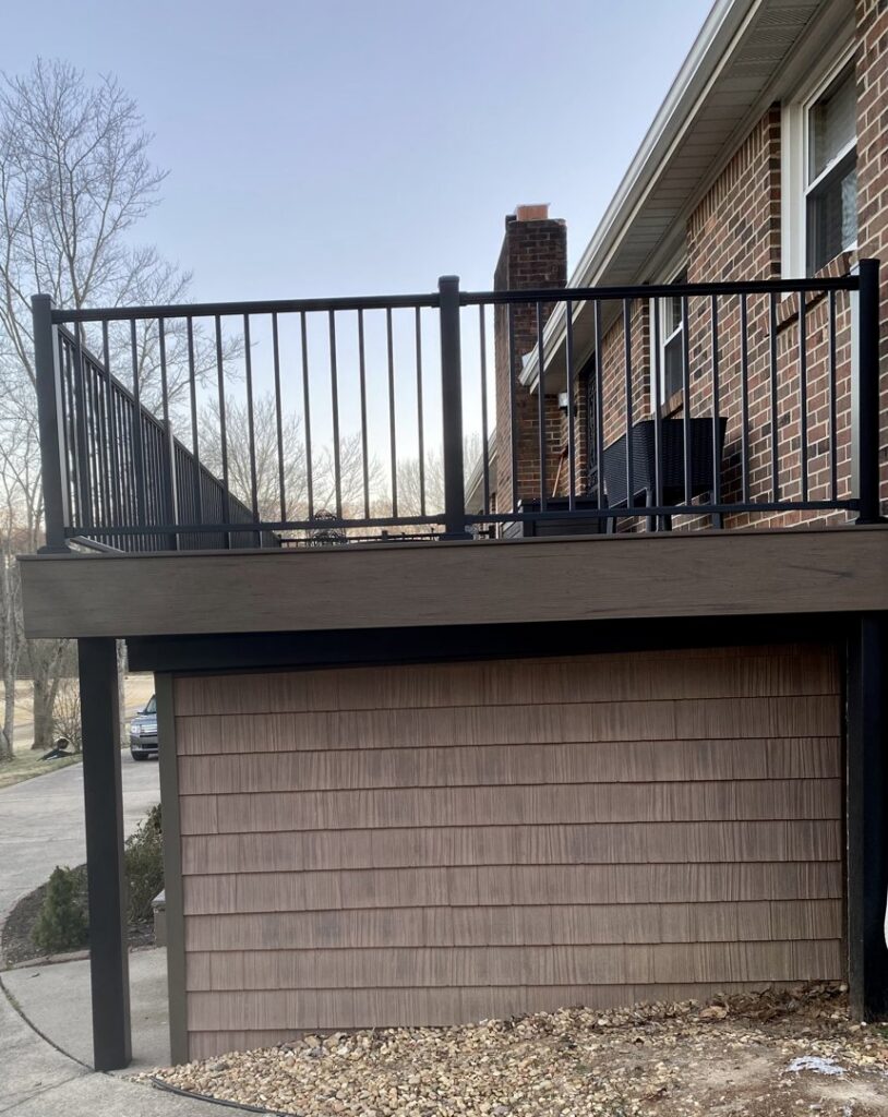 A newly installed deck with modern black metal railings by Tactical Contracting LLC in Clarksville, TN, enhancing outdoor living spaces.