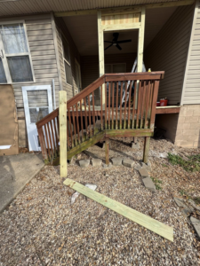A deck renovation project with new lumber and a door on site, handled by Screw it, Call Rod in Rogers, AR.