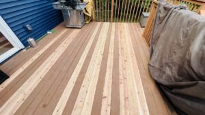 A residential deck showing new and old boards, indicating deck repair and replacement services by Clear Choice Handyman LLC in Woodbury, MN.