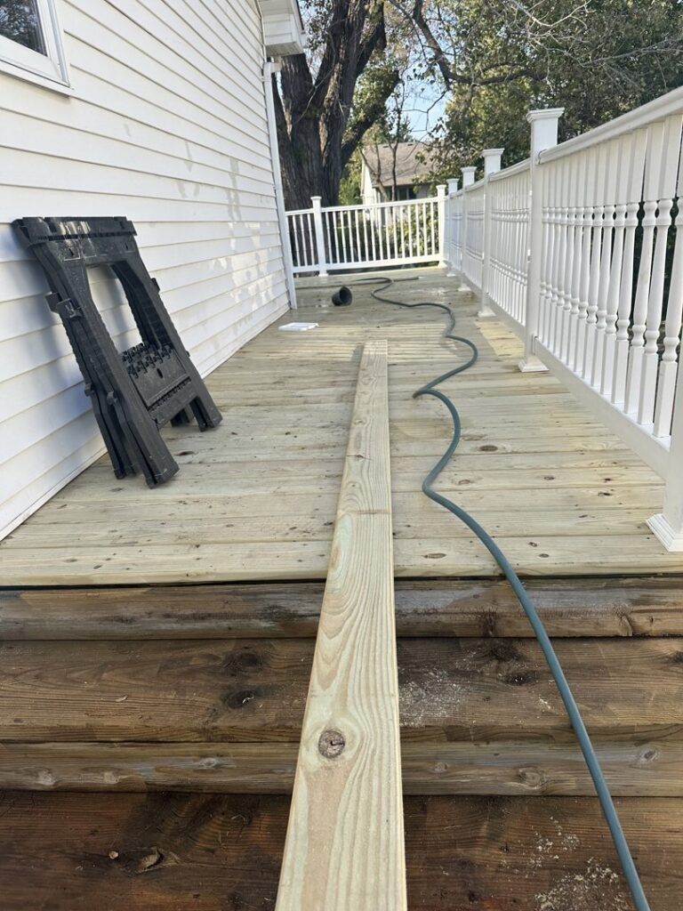 A new wooden board laid on a deck during repair and construction by Jewell Services handyman in Des Moines, IA.