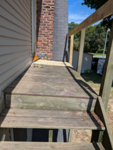 A deck repair in progress, showing old and new wood planks, by Handyman Service in Lafayette, IN.
