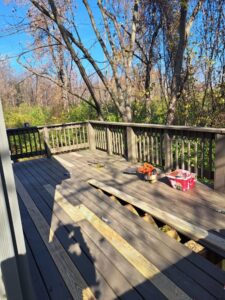 A wooden deck with boards removed and tools, indicating deck repair in progress by JAMS Property Preservation LLC in Dayton, OH.