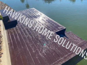 A freshly stained wooden deck next to the water, completed by Hawkins Home Solutions in Glendale, AZ.