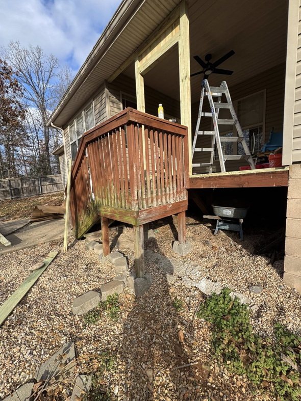 A wooden deck and stairs undergoing repair or renovation, with a ladder, by Screw it, Call Rod in Rogers, AR.