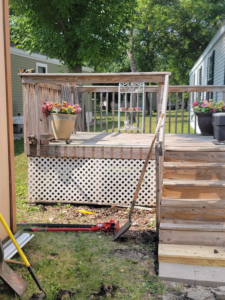 Existing wooden deck and stairs with tools on the ground, indicating repair or maintenance work by Becker Services ND in West Fargo, ND.