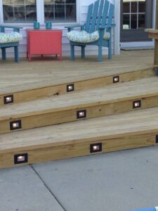 Newly installed wooden deck stairs with integrated lighting by Isac's General Services LLC in Henrico, VA