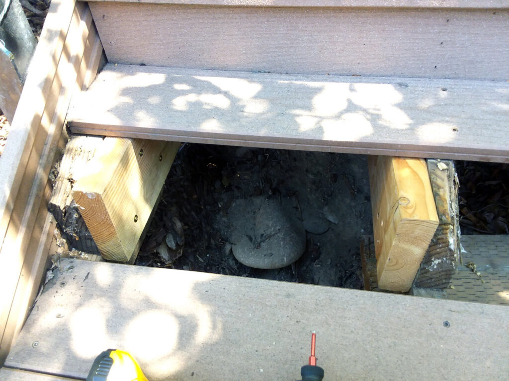 Exposed wooden supports under a deck step, indicating repair or construction work by Boise Handyman & Remodel in Boise, ID.