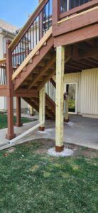 New support posts and stairs installed for an outdoor deck, demonstrating structural repair by Go Joe Handyman in Overland Park, KS.