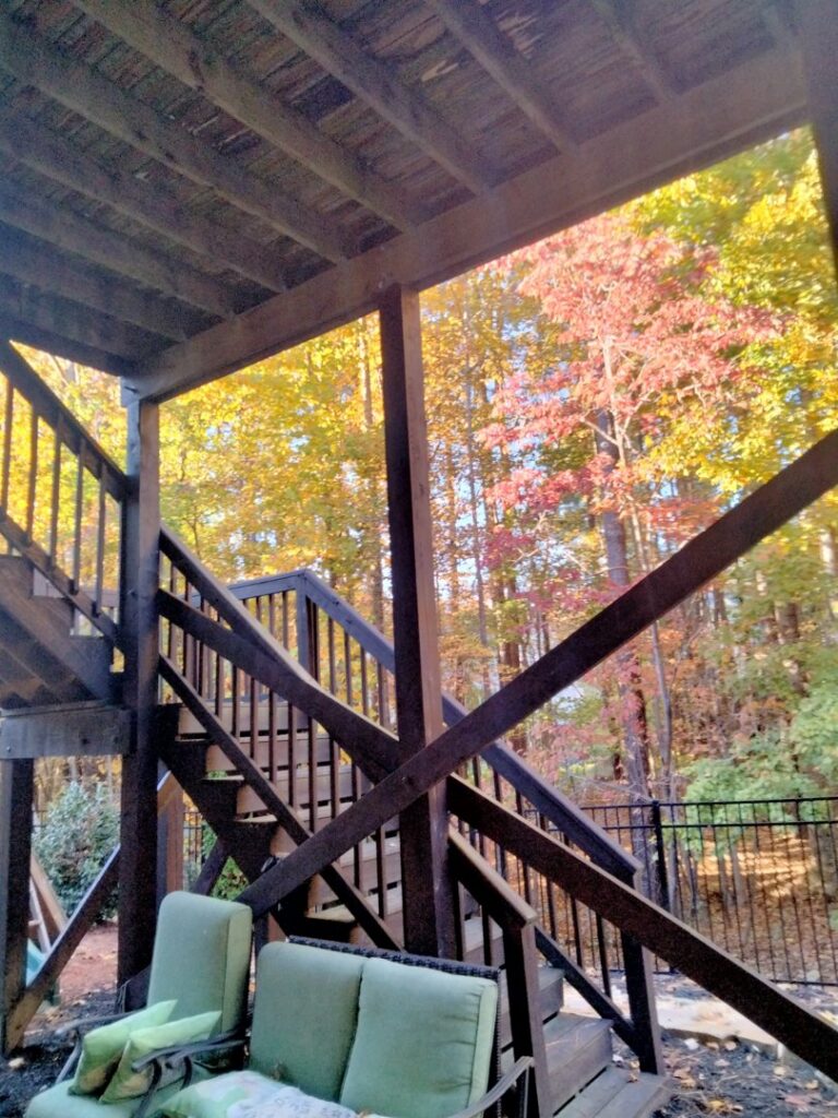 View from underneath a wooden deck, showing its structure, maintained by Mels Haul & Junk Removal in Raleigh, NC.