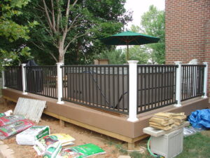 A newly built deck with a hot tub and black railings by Quality Fence & Deck Co. in Frederick, MD.