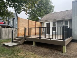 A newly built deck featuring a stylish wooden privacy screen by Chad Fry the Deck Guy LLC in Blue Springs, MO.