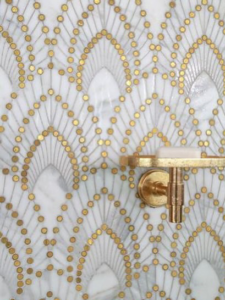 Close-up of decorative bathroom wall tiles and a newly installed wall-mounted soap dish by Husband for Hire in Suffolk, VA.