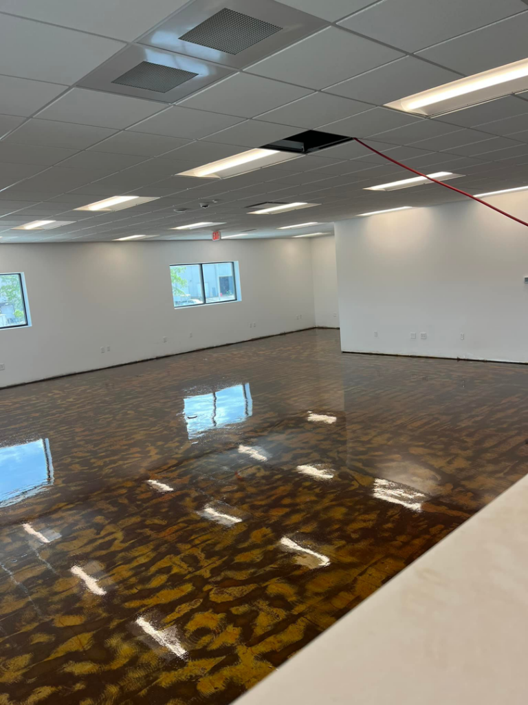 A decorative brown and gold epoxy floor coating in a commercial building by Quality Painting of Raleigh in Raleigh, NC.