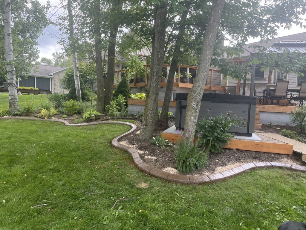 Decorative concrete landscape edging installed in a backyard by Premier Edge Concrete in Grand Rapids, MI